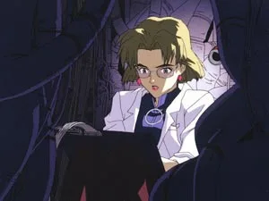 MAGI内部の配線に囲まれ端末から逆ハッキングを実行する赤木リツコの第拾参話公式場面画像